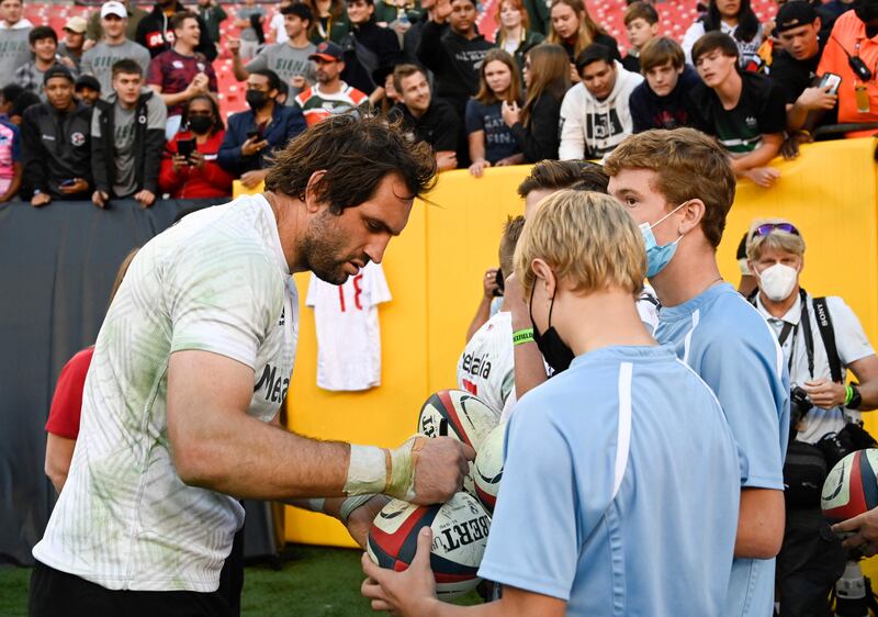Samuel Whitelock of the All Blacks signs autographs after the match. AFP