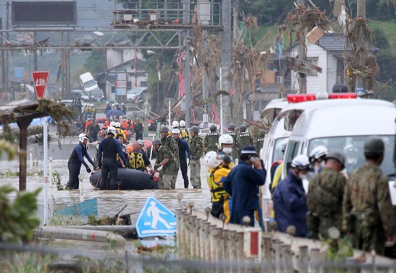 Residents are evacuated from flood-affected area by rubber boats in Kuma village, Kumamoto. AFP