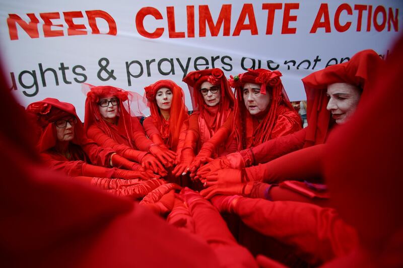 Red Rebels from Extinction Rebellion are seen during a School Strike for Climate Australia (SS4C) 'Solidarity Sit-down' outside of the office of the Liberal Party of Australia in Sydney, Australia, November 29, 2019.  REUTERS
