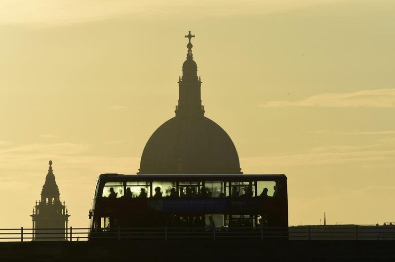 A bus carries commuters as it travels over Waterloo Bridge in London, Britain. Toby Melville / Reuters