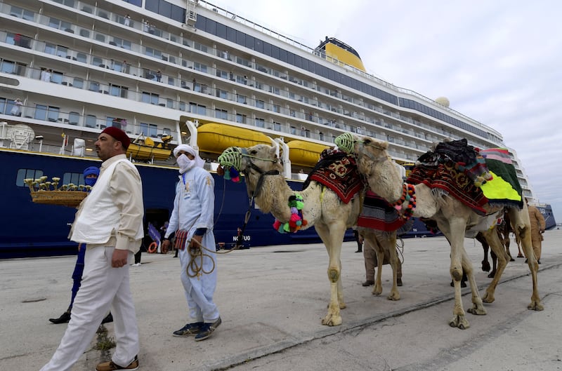 Men lead camels at the port of La Goulette in Tunis, as Tunisia welcomes the first cruise from Europe since 2019 due to the Covid-19 pandemic. AFP