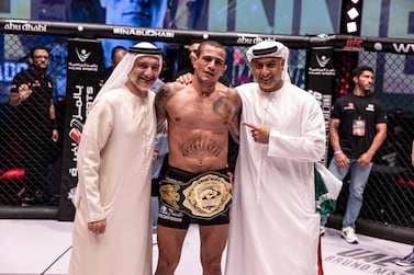 Bruno Machado is joined by Saleh Al Geziry, director general of Department of Culture and Tourism Abu Dhabi, and Abdulmunem Al Hashemi, chairman of Palms Sports, after presenting the title belt.
