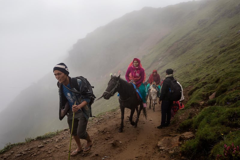 A group of elderly female devotees ride on horses as they travel to Gosaikunda Lake. Narendra Shrestha/EPA