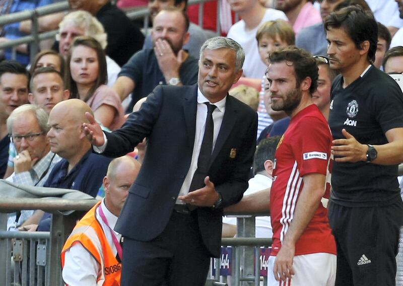 Manchester United's Spanish midfielder Juan Mata (C) talks with Manchester United's Portuguese manager Jose Mourinho (L) and  Manchester United's Portuguese assistant manager Rui Faria (R) after he is substituted late on during the FA Community Shield football match between Manchester United and Leicester City at Wembley Stadium in London on August 7, 2016.  / AFP PHOTO / Ian Kington / NOT FOR MARKETING OR ADVERTISING USE / RESTRICTED TO EDITORIAL USE