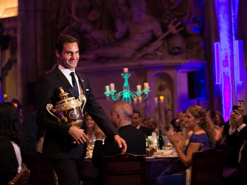 The 2017 Wimbledon Men's Singles champion Roger Federer of Switzerland arrives with his trophy for the Champions Dinner at The Guildhall in London, late Sunday July 16, 2017. (Jon Buckle/AELTC, Pool via AP)