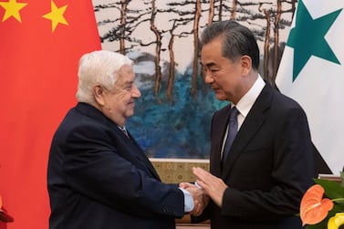 Syrian Foreign Minister Walid Muallem, left, shakes hands of Chinese Foreign Minister Wang Yi after a press conference at the Diaoyutai state guesthouse, Tuesday, June 18, 2019. AP