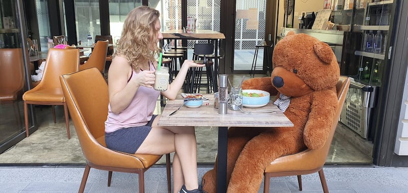 A customer dines with a social distancing teddy bear at Healthy Little Secrets DIFC. Currently, the bears are placed on tables to indicate that the table is blocked. However, diners who come in alone can choose to sit opposite a bear, as long as they are adhering to social distancing guidelines and keeping an empty table between them and other diners. Courtesy of Healthy Little Secrets