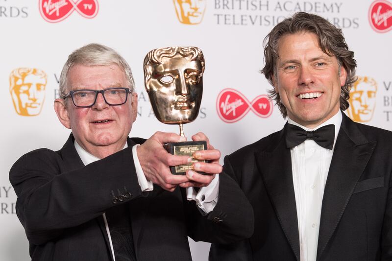 Motson is presented with a Bafta in 2018 in London, by comedian John Bishop. Getty Images