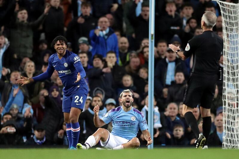 Manchester City's Sergio Aguero and Chelsea's Reece James react as referee Martin Atkinson looks on. Reuters