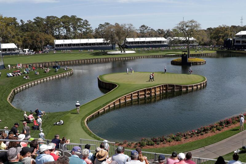 Cameron Champ, Nate Lashley, Kevin Tway walk the 17th green, during Round 1 of The Players Championship golf tournament  in Ponte Vedra Beach, Florida, on Thursday, March 12. AP
