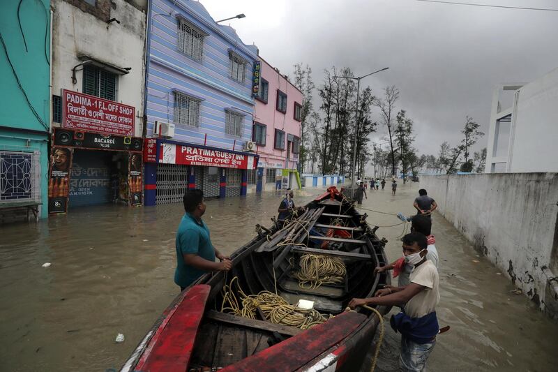 Villagers prepare a boat to rescue people during a flood as Cyclone Yaas makes landfall in Digha, near the Bay of Bengal in India. EPA