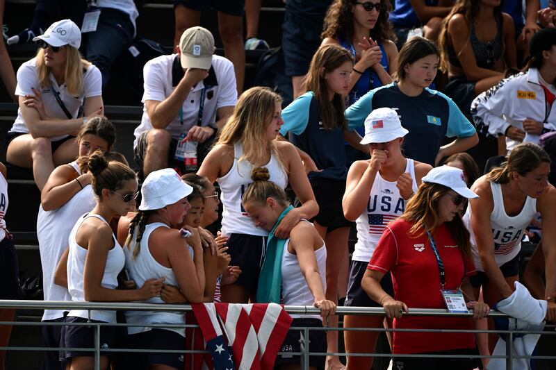 Distressed fans and teammates after Anita Alvarez had to be rescued from the pool after fainting. AP