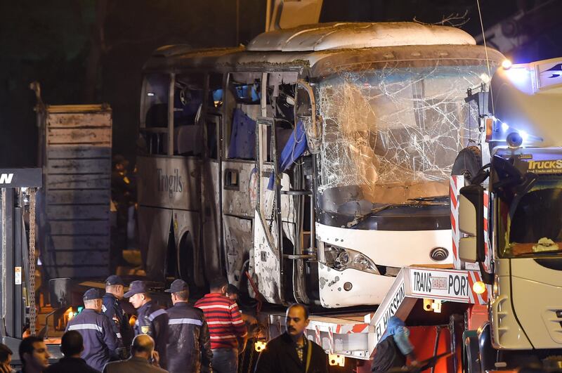 A tourist bus which was attacked by a roadside bomb is towed away from the scene, in Giza province south of the Egyptian capital Cairo. AFP