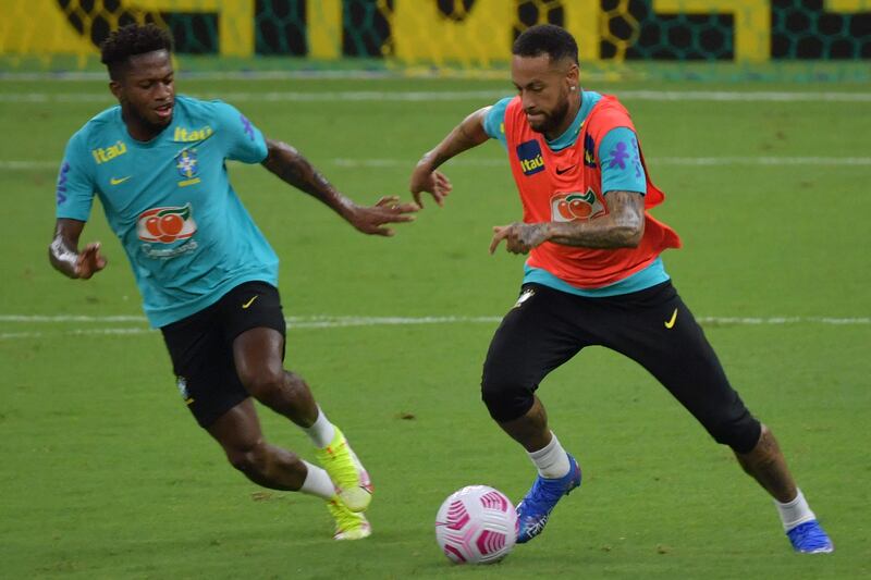 Brazil's Neymar vies for the ball with Fred during a training session. AFP