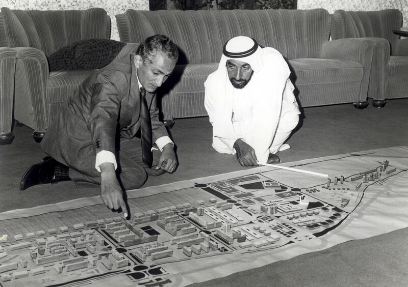 Dr Makhlouf shows Sheikh Zayed one of the city's design features. Photo: National Centre for Documentation and Research