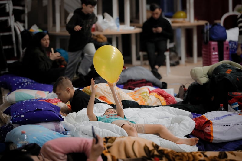 A child who fled the Russian invasion in neighbouring Ukraine plays with a yellow balloon in a ballroom converted into a makeshift refugee shelter at a four-star hotel in Suceava, Romania. AP