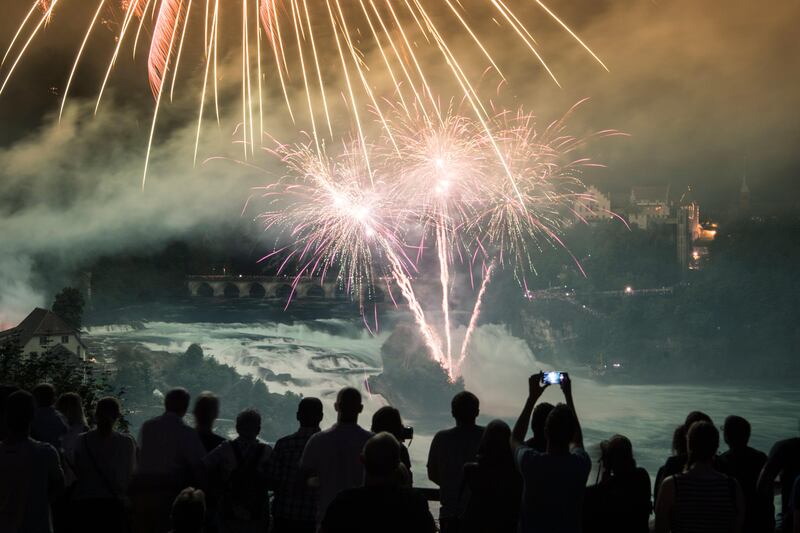 Fireworks illuminate the sky over Neuhausen at the river Rhine fall, Switzerland. Switzerland celebrates the National Day on 01 August.  Ennio Leanza.