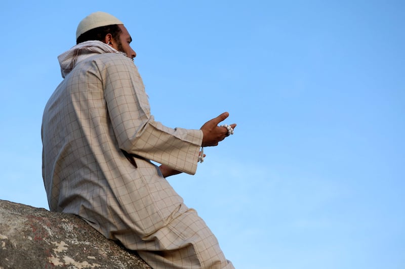 A Muslim pilgrim prays at Jabal Al Noor 'mountain of light' in Makkah, Saudi Arabia. AFP