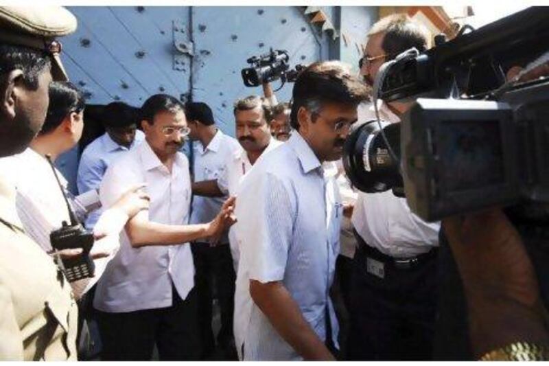 Central Bureau of Investigation officials escort Ramalinga Raju, the founder and former chairman of Satyam, into custody last year. Mahesh Kumar A / AP Photo