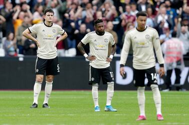 Fred, centre, and Harry Maguire, left, of Manchester United look dejected after West Ham's second goal on Sunday. Getty