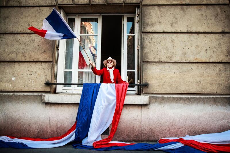 An elderly woman holds a French flag as residents of Saint Mande celebrate the end of containment measures and thank medical and health care personnel amid the ongoing coronavirus pandemic in Saint Mande, near Paris, France. France begins a gradual easing of lockdown measures and restrictions although the Covid-19 epidemic remains active.  EPA