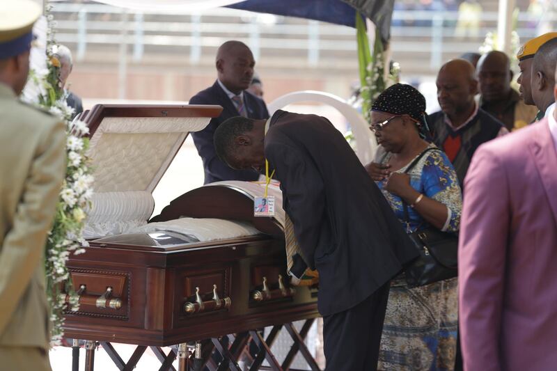 Mourners pay their last respects at the coffin of former Zimbabwean President Robert Mugabe at the Rufaro Stadium in Harare, where the body is on view at the stadium for a second day. Mugabe died last week in Singapore at the age of 95. He led the southern African nation for 37 years before being forced to resign in late 2017. AP Photo