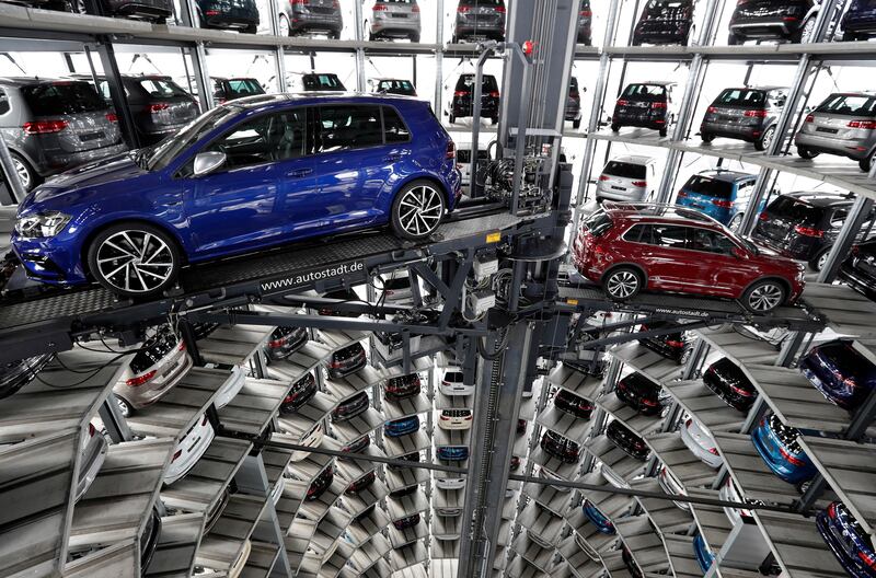 FILE - In this March 14, 2017 file photo Volkswagen cars are lifted inside a delivery tower of the company in Wolfsburg, Germany. Automaker Volkswagen saw profit drop by half in the third quarter due to expenses for fixing and buying back diesel cars in the United States. The Wolfsburg-based automaker said Friday, Oct. 27, 2017, that it was otherwise a â€œstrong third quarterâ€ and raised its earnings outlook for the full year. (AP Photo/Michael Sohn, file)