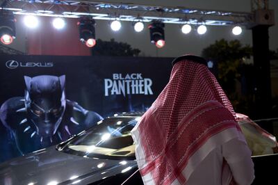 A Saudi man looks at a car during a cinema test screening in Riyadh on April 18, 2018.
Blockbuster action flick "Black Panther" play at a cinema test screening in Saudi Arabia on April 18, the first in a series of trial runs before movie theatres open to the wider public next month. The conservative kingdom lifted a 35-year ban on cinemas last year as part of a far-reaching liberalisation drive, with US giant AMC Entertainment granted the first licence to operate movie theatres. / AFP PHOTO / Fayez Nureldine