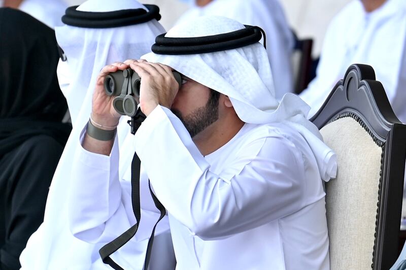Sheikh Hamdan watches the drills through binoculars. Photo: Dubai Media Office