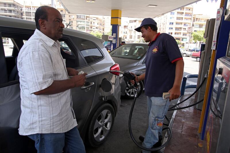 A petrol station attendant fuels a car at a gas station in Cairo. The Egyptian government increased the price of gasoline by at least 42.8 per cent as part of an economic reform programme. Khaled Elfiqi / EPA