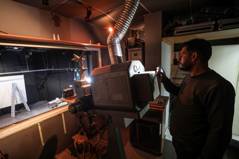 Tariq Al Shawa, manager of the Holst Park and Cultural Centre in Gaza City since 1998, inspects its projector as the venue undergoes renovation. Majd Mohamad for The National