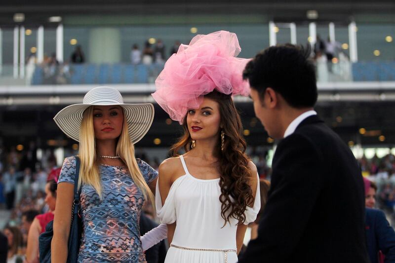 Dubai, March 30, 2013 -  A pair of women sport large hats at the Dubai World Cup at Meydan in Dubai, March 30, 2013. (Photo by: Sarah Dea/The National)