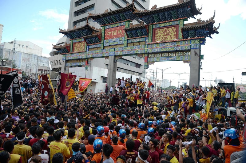 Catholic devotees crowd around to try to touch the Black Nazarene statue. AFP