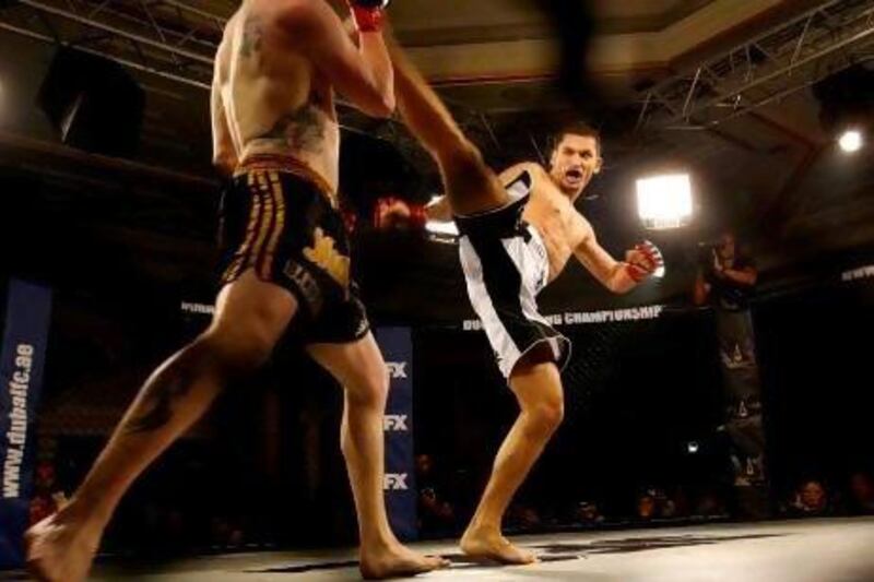 Malik Omarov lands a kick on Stuart Davies during the Dubai Fighting Championship.