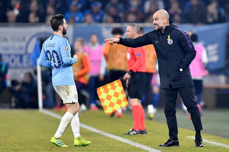 Manchester City coach Pep Guardiola, right, gives instructions from the side line to his player Bernardo Silva during the first leg, round of sixteen, Champions League soccer match between Schalke 04 and Manchester City at Veltins Arena in Gelsenkirchen, Germany, Wednesday Feb. 20, 2019. (AP Photo/Martin Meissner)