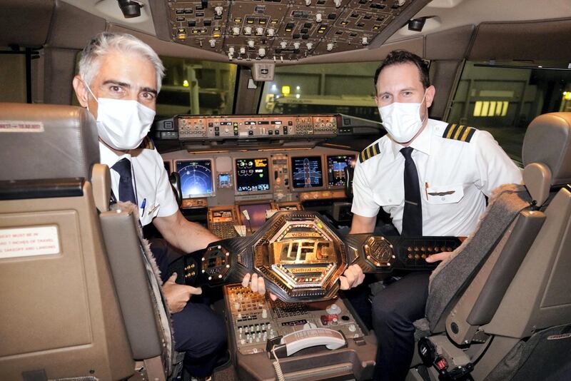 Etihad pilots showcase the UFC championship belt. Etihad Airways