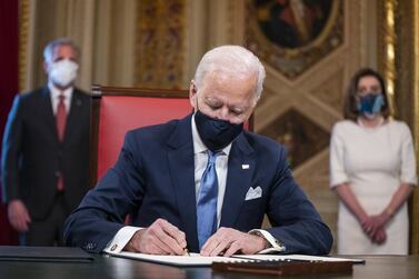 US President Joe Biden signs documents in the President's Room at the Capitol following the inauguration in Washington, January 20, 2020. EPA/Bloomberg