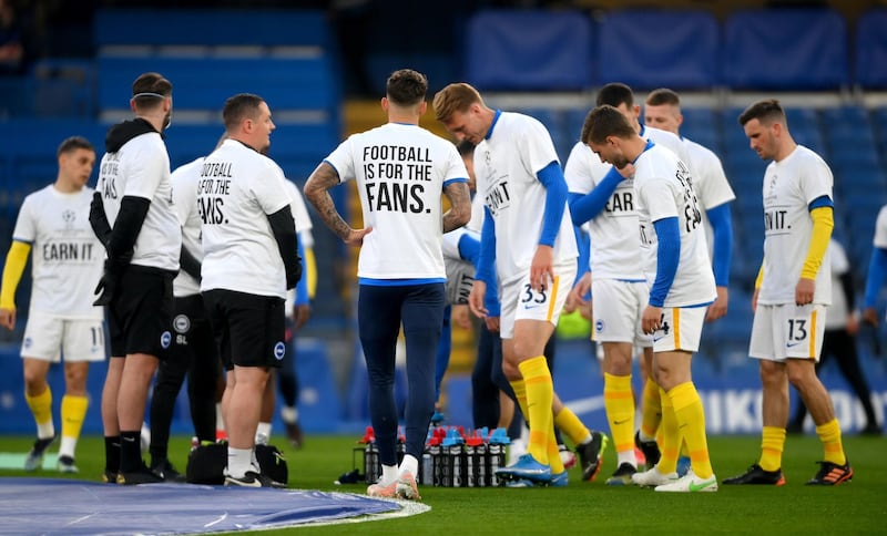 Brighton players wearing t-shirts opposing the proposed European Super League. PA