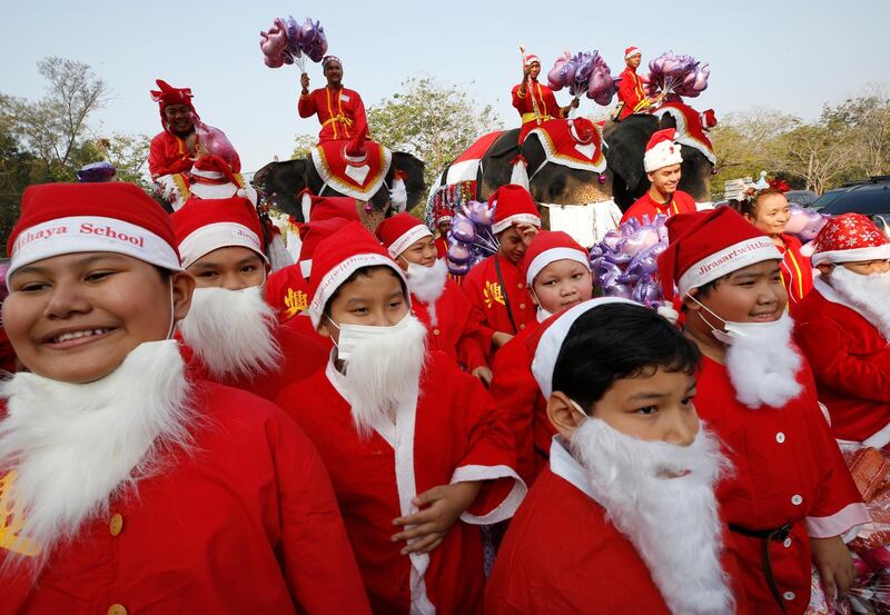 Thai children and elephants dressed as Santa Claus attend Christmas celebrations at a school in the world heritage city of Ayutthaya, north of Bangkok, Thailand.  EPA
