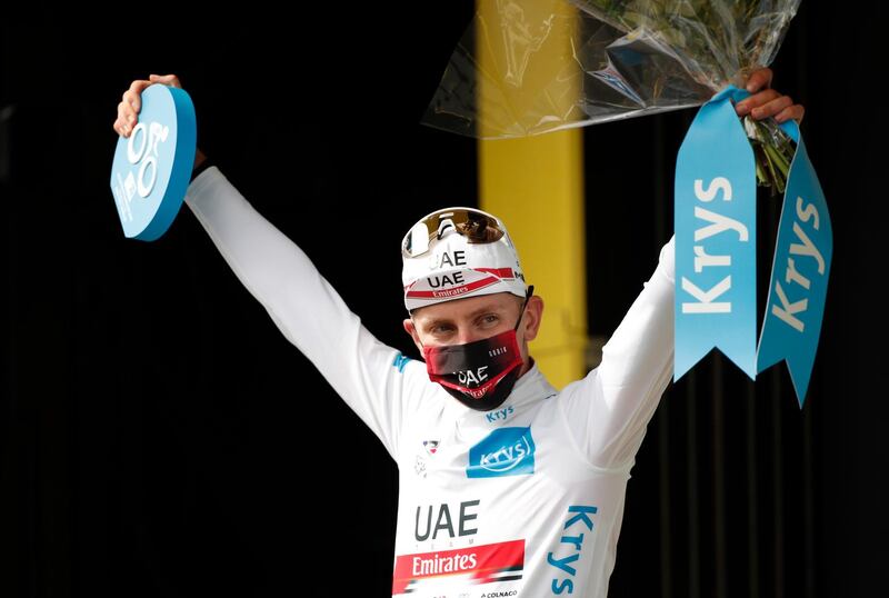 UAE Team Emirates rider Tadej Pogacar celebrates on the podium wearing the white jersey for best young rider.