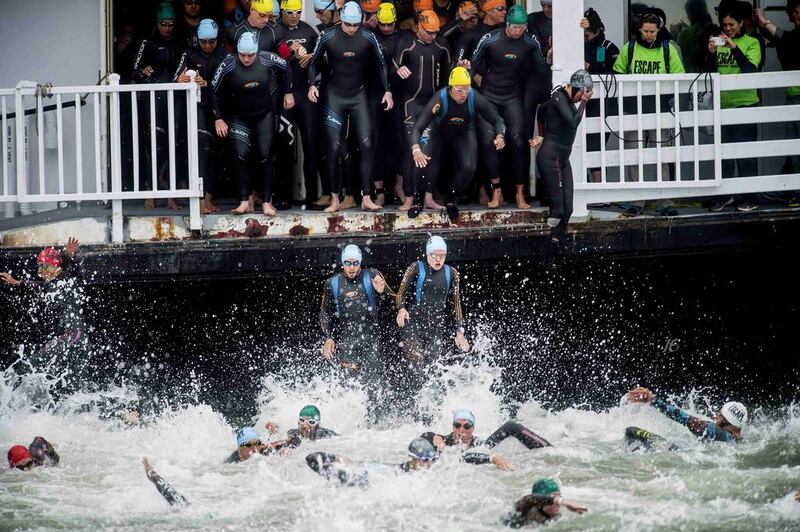 Swimmers jump into San Francisco Bay at the beginning of the Escape from Alcatraz Triathlon on Sunday. Noah Berger / Reuters / June 1, 2014