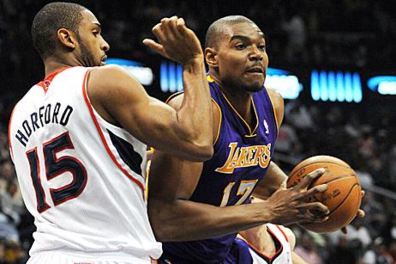 The Los Angeles Lakers centre Andrew Bynum, right, drives against the Atlanta Hawks centre Al Horford.