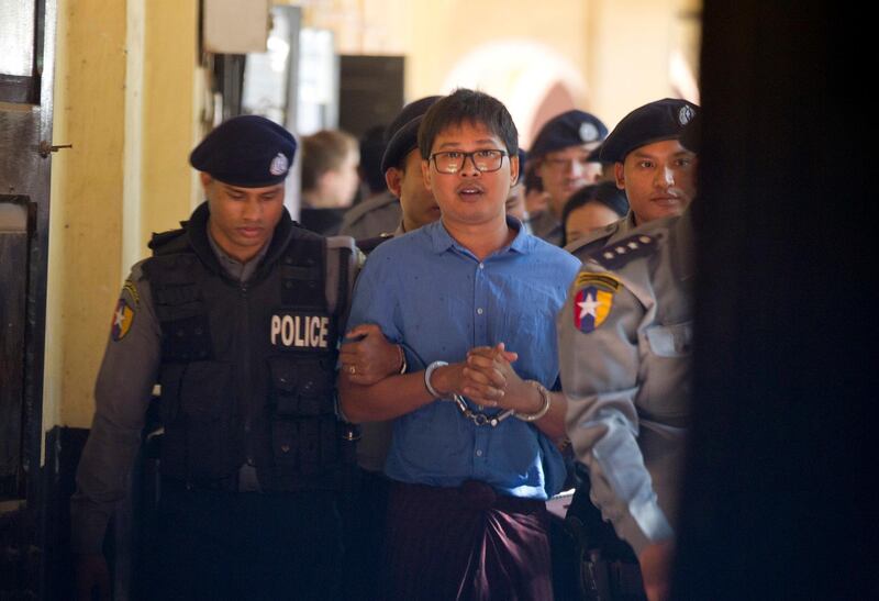 Reuters journalist Wa Lone is escorted by police as he leaves court Wednesday, Jan. 10, 2018, outside Yangon, Myanmar. (AP Photo/Thein Zaw)
