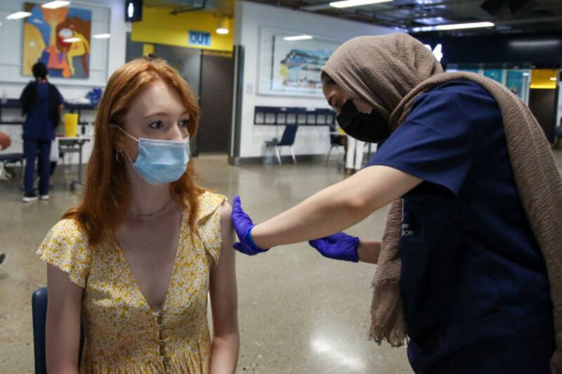 A health worker administers a dose of Pfizer-BioNTech's Covid-19 vaccine at Tottenham Hotspur Stadium in north London as the UK vaccination drive continues. Getty
