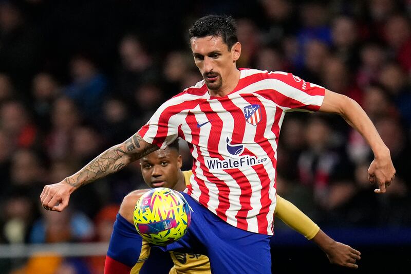Atletico Madrid's Stefan Savic, right, and Barcelona's Ansu Fati challenge for the ball. AP Photo