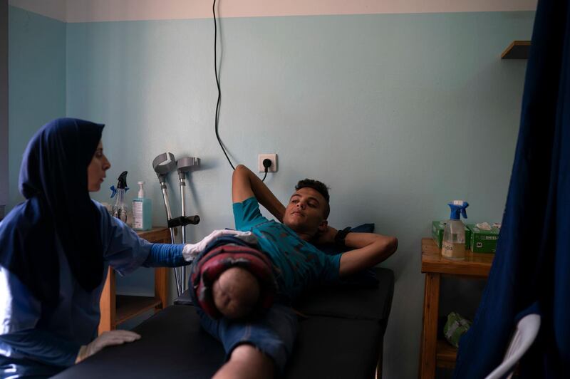 18-year-old Atalla Fayoumi, who had his leg amputated after he was shot in a demonstration in April, attends a physical therapy session in a clinic run by MSF (Doctors Without Borders) in Gaza City. Ever since Hamas launched demonstrations in March against Israel's blockade of Gaza, children have been a constant presence in the crowds. Since then, U.N. figures show that 948 children under 18 have been shot by Israeli forces and 2,295 have been hospitalized, including 17 who have had a limb amputated. AP