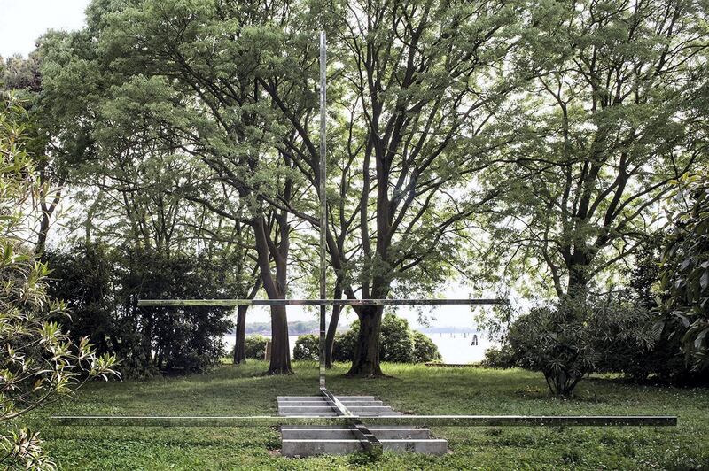 <p>In a grassy clearing in a wooded garden on the island of San Giorgio Maggiore in the Venetian Lagoon, an odd structure in stainless steel spreads out in straight lines.