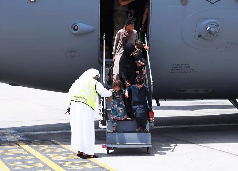 An Emirati official welcomes Afghan evacuees to the UAE. Photo: Twitter/@AnwarGargash