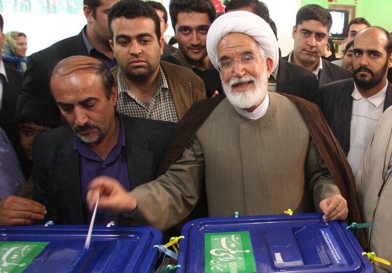 (FILES) This file photo taken on June 12, 2009 shows Iranian presidential candidate Mehdi Karroubi casting his ballot at a polling station in Tehran. 
Iranian opposition leader Mehdi Karroubi, under house arrest for the past six years, was hospitalised on August 17, 2017 after going on hunger strike to demand a trial, his family told local media. / AFP PHOTO / AFP FILES / ATTA KENARE