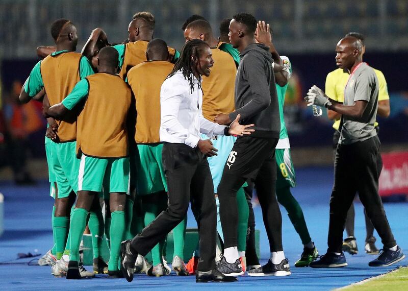 Senegal's Ismaila Sarr celebrates scoring their first goal with teammates and Senegal coach Aliou Cisse. Reuters